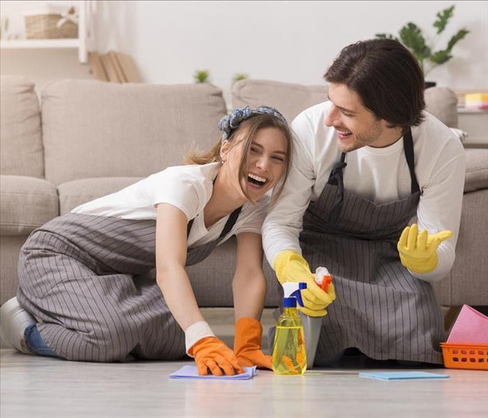 Young couple cleaning their floor.
